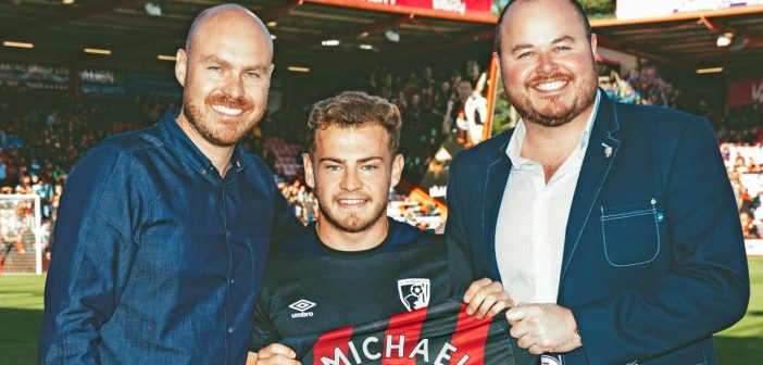 Bournemouth player presenting a shirt to the business