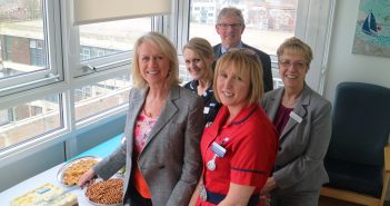 image of Sally Taylor cutting the cake at the official opening of the unit with Patricia Reid, Mr Tim Hillard, Benita Fillingham and Debbie Fleming
