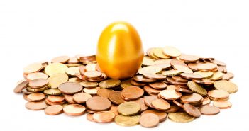 image of an easter egg on top of a pile of coins