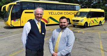Two men stood by a coach