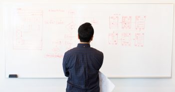 Man in front of white board
