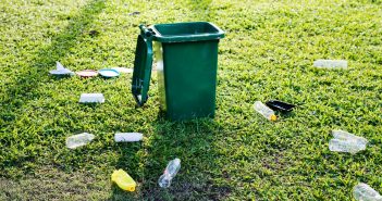 Bottles strewn around a bin