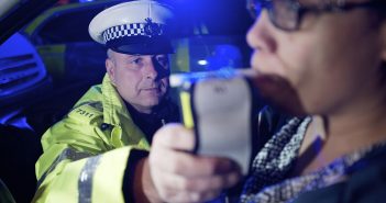Policeman using a breathalyzer